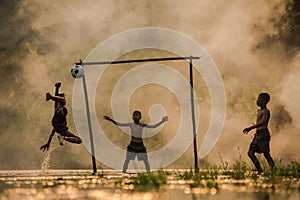 Football players The three children are playing football on the