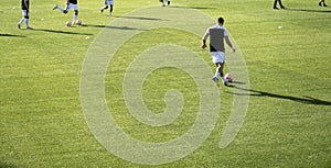 football players warming up before a football match