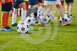 Football practice for youth. Children soccer training background. Group of young boys training soccer drills on green grass