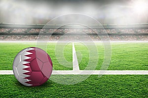 Football With Qatar Flag in Soccer Stadium With Copy Space photo