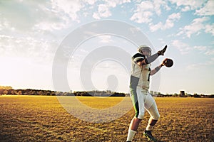 Football quarterback throwing a long pass during team practice