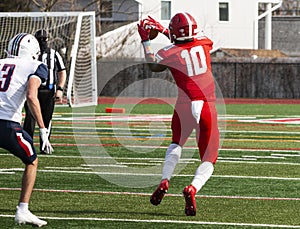 Football receiver catching a pass during a game