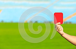 Football referee showing red card at stadium