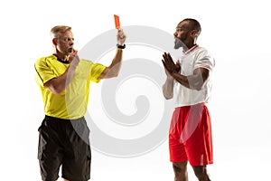 Football referee showing a red card to a displeased player isolated on white background