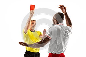 Football referee showing a red card to a displeased player isolated on white background