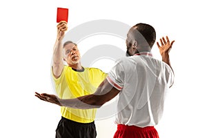 Football referee showing a red card to a displeased player isolated on white background