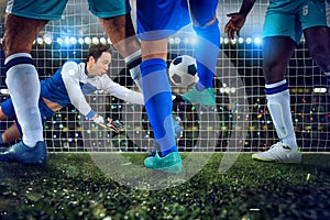 Football scene with soccer players and goalkeeper at the stadium