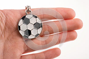 Football shaped keyholder in hand