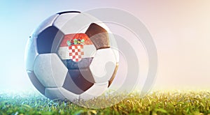 Football soccer ball with flag of Croatia on grass