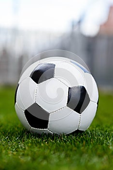 Football or soccer ball on grass,