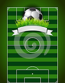 Football soccer ball on green field background