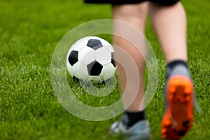 Football or soccer ball at the kickoff of a game. Soccer free kick at a grass pitch