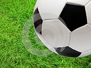 Football soccer ball over green grass