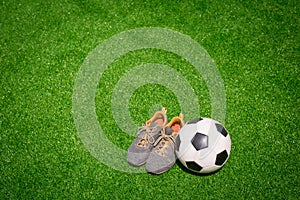 Football, Soccer ball and sport shoes on green grass