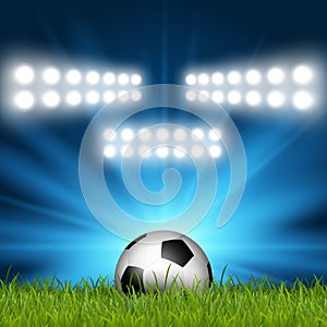 Football / soccer ball under spotlights