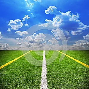 Football and soccer field grass stadium Blue sky background