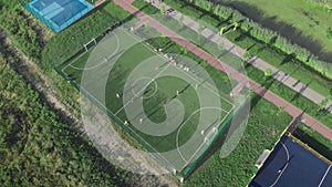 Football soccer field outdoors. People playing football at sunny summer day. Sports playground from birds eye view. Athletic baske