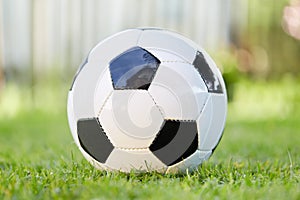 Football of soccer game lying on the grass of the garden