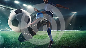 Football or soccer player in action on stadium with flashlights, kicking ball for winning goal, wide angle photo
