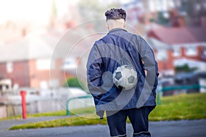 Football soccer player going to training ground in afternoon alone