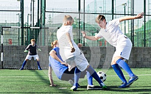 Football soccer players with ball. Footballers kicking football match on the pitch