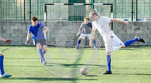 Football soccer players with ball. Footballers kicking football match on the pitch