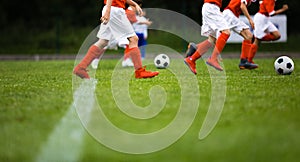 Football soccer team exercising with balls. Young athletes during the team training before the match