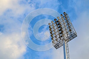 Football stadium spotlight pole on blue sky