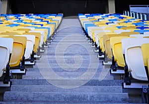 Football stadium tribune. Plastic seats of the open stadium, close-up. Rows of seats for spectators of sporting events