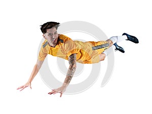 Football striker player with yellow team suit jumps