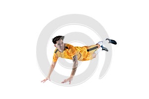Football striker player with yellow team suit jumps photo