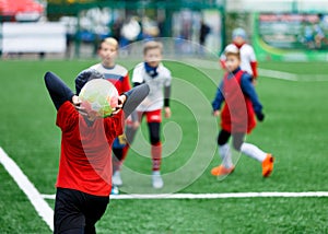 Football teams - boys in red, blue, white uniform play soccer on the green field. boys dribbling. dribbling skills. Team game