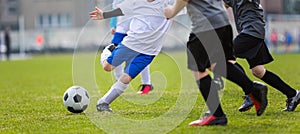 Football Tournament for Youth Soccer Clubs Academies. School Sports Competition. Four Young Boys in White and Black Soccer Jersey photo