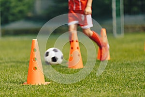 Football Training Background. Orange Practice Cone. Player Running Ball in Slalom Drill in Blurred Background