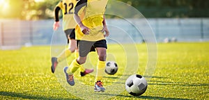 Football Training on the Pitch. Boys on Soccer Training Session. Kids Footballers Running the Ball photo