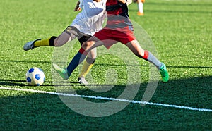 Football training soccer for kids. Boy runs kicks dribbles soccer balls. Young footballers dribble and kick football ball in game. photo