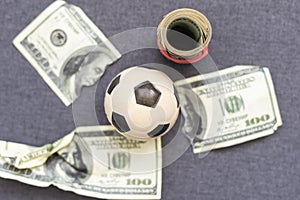 Football transfer concept image. Money background texture. Soccer ball with many money.