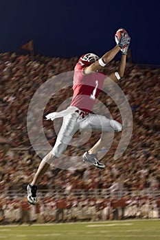 Football Wide Receiver Making a Leaping Catch