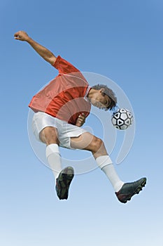 Footballer Heading The Ball