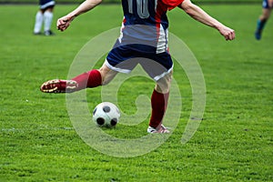 Footballer kicking the ball during the football match