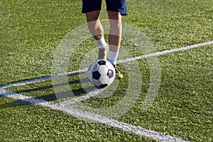 Footballer is preparing to strike a corner kick on the goal.