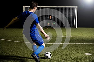 Footballer shooting a penalty kick