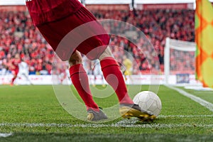 Footballer takes the corner.