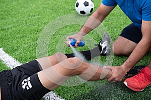 Footballer wearing a blue shirt, black pants injured