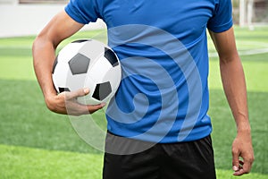 Footballer wearing a blue shirt, black pants injured