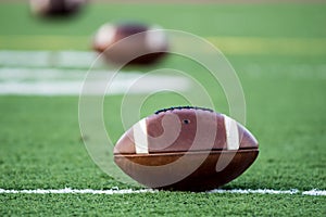 3 footballs on turf photo