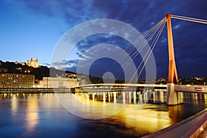 Footbridge, courthouse and basilica at Lyon city with citylights, France