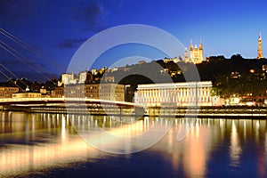 Footbridge, courthouse and basilica at Lyon city with citylights, France