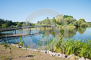 Footbridge over the lake to Seeon cloister, tourist destination photo