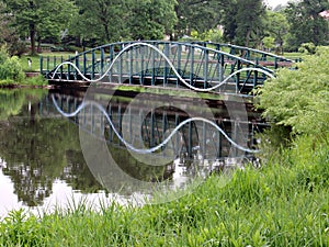 Footbridge Reflecting in Still Pond